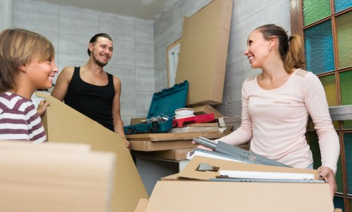 Removal team packing and loading household items for a house move