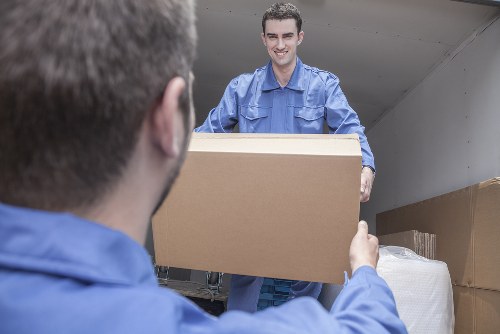 Local house removals team loading furniture for a home move in House