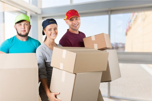 Removals crew carefully carrying furniture through a residential property