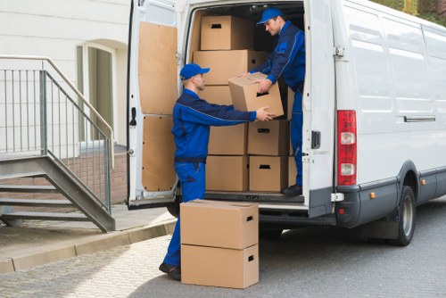 Mover carrying boxes and furniture from a family house