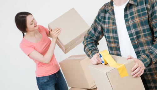 Local office removals team handling furniture from a house-based workspace