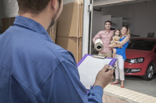 House move with boxes and furniture being loaded into a van