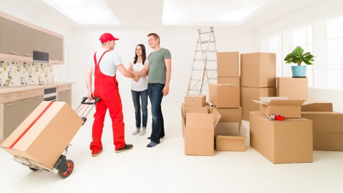 Moving team handling furniture through a home hallway